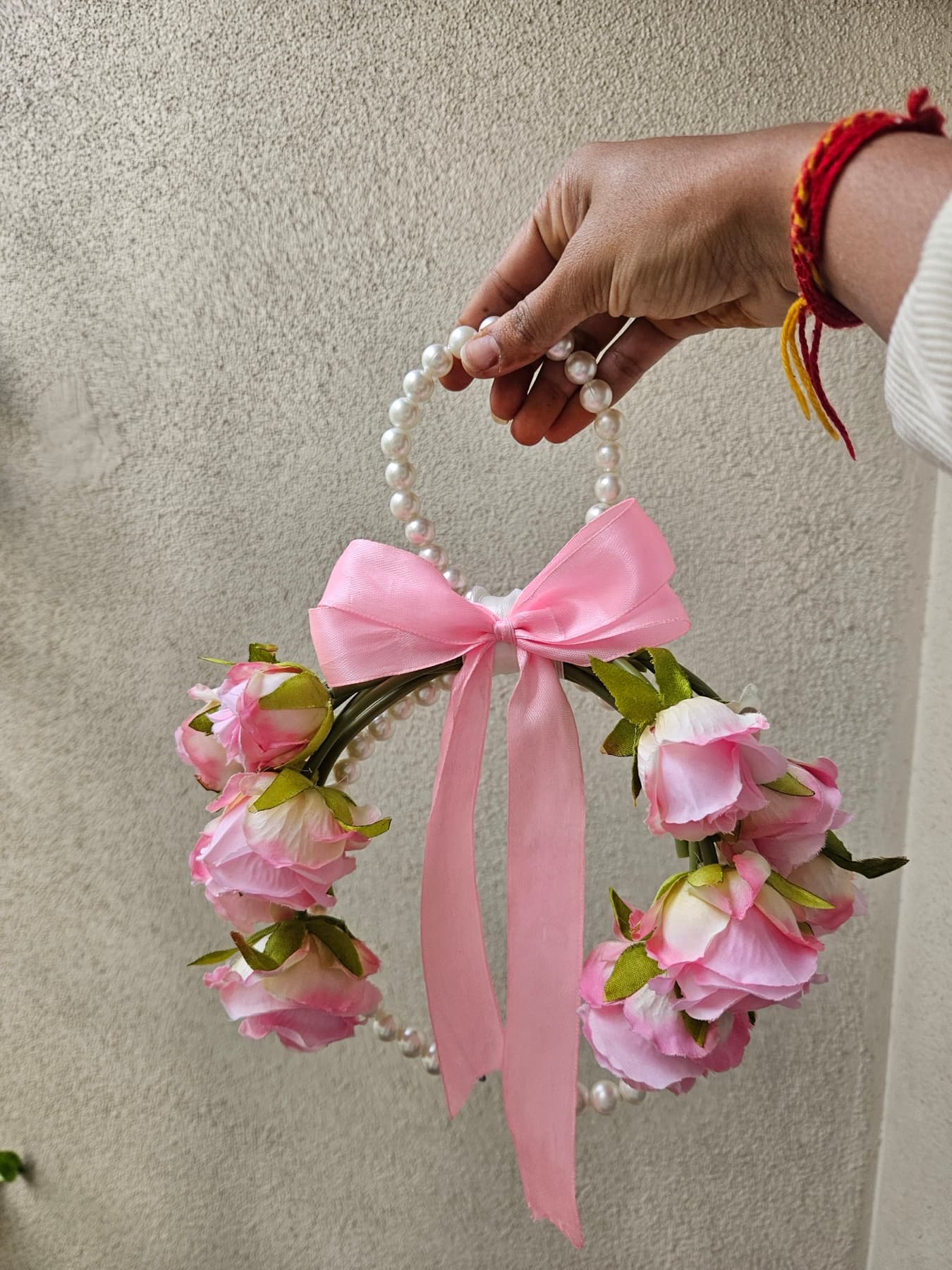 Pink rose purse bouquet with a wide satin bow