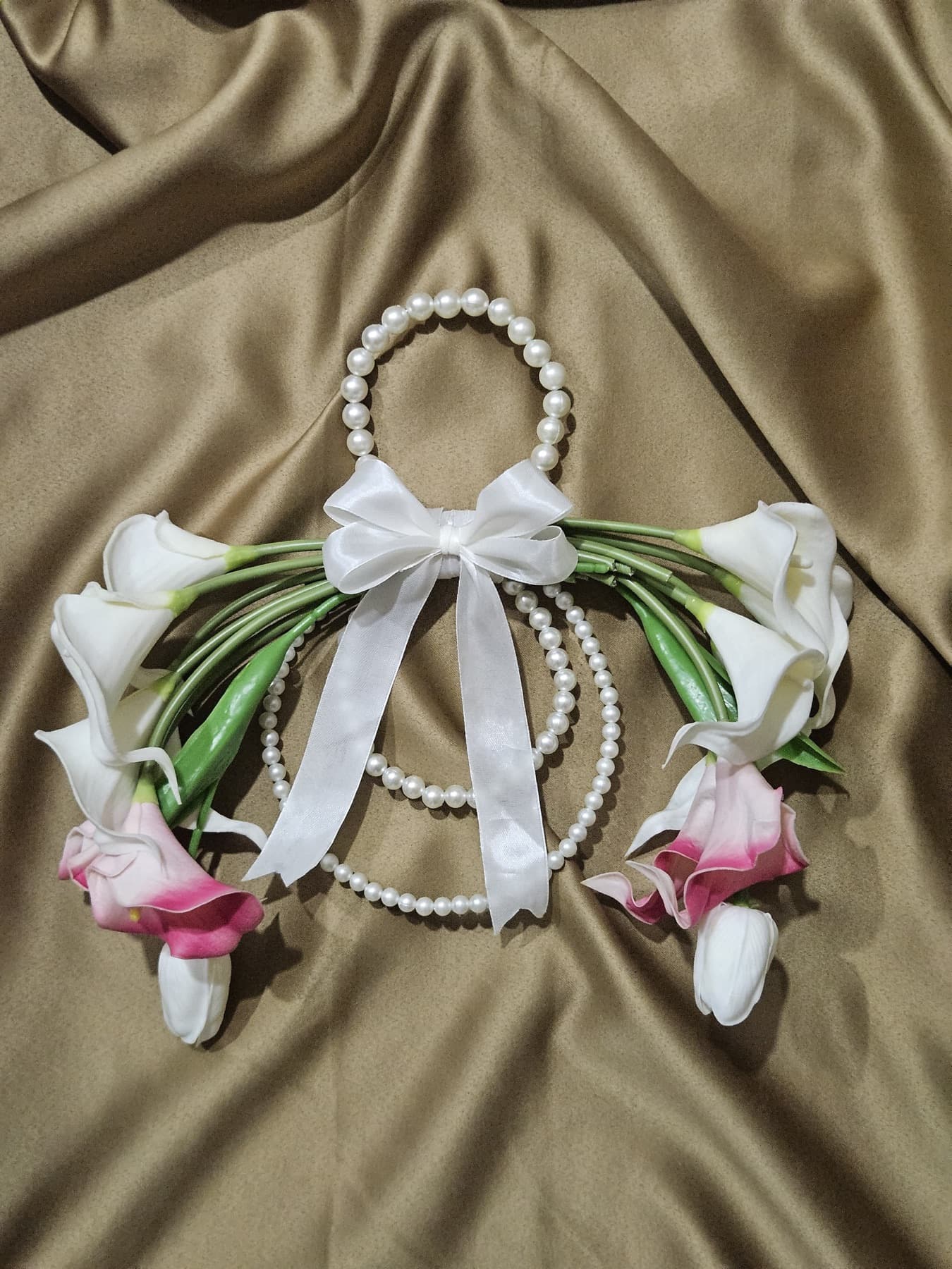 White and pink calla lily purse bouquet on gold silk