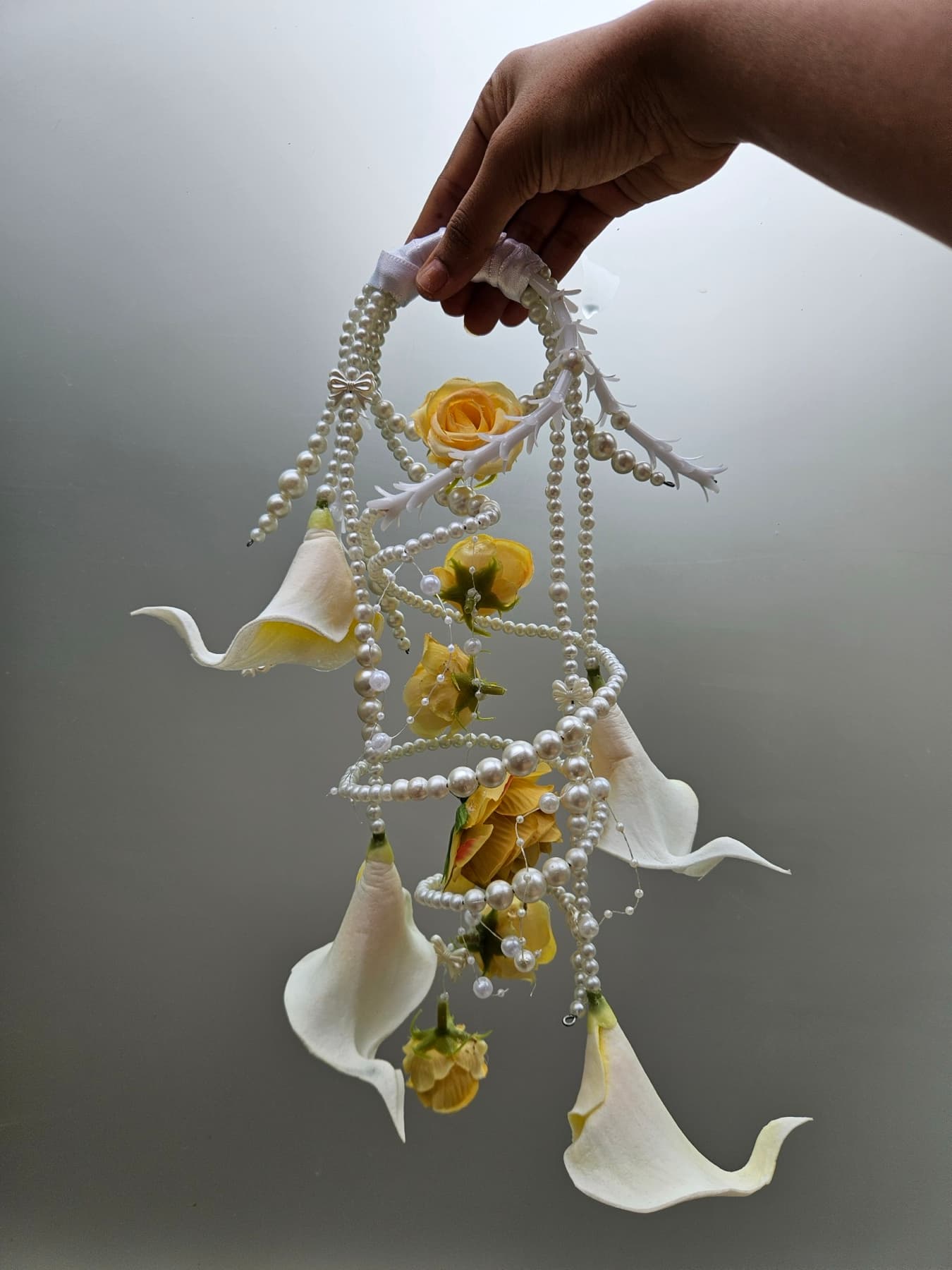Yellow calla lily purse bouquet with twirling pearl strands