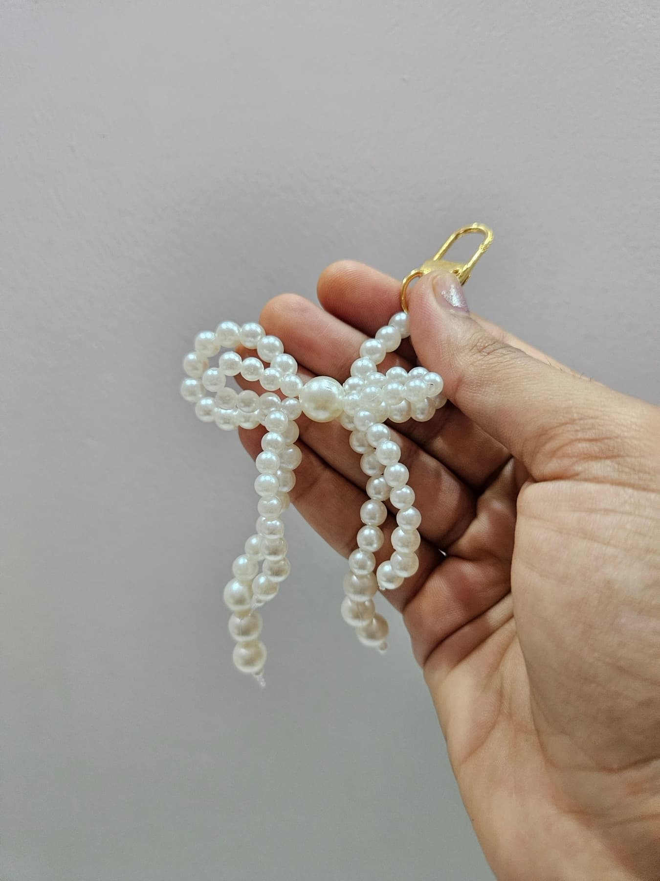 Pearl bow bag charm with trailing strands
