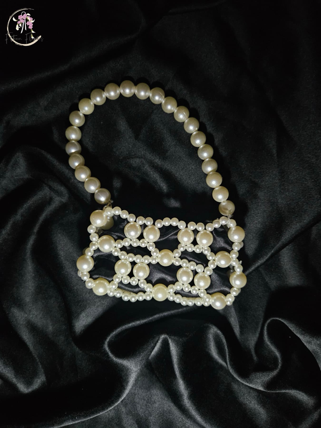 Miniature pearl pouch on black satin